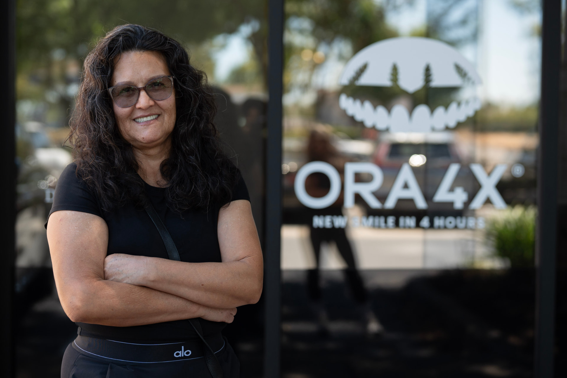 Smiling patient outside the ORA 4X dental implant center