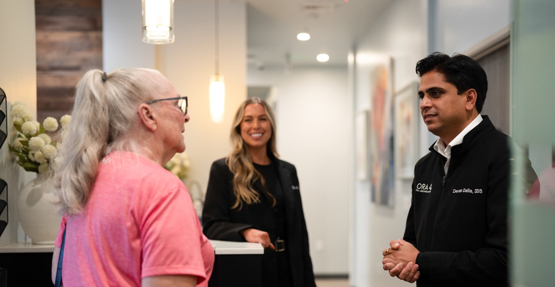 Dr. Dalla greeting a patient at the ORA 4X implant center in Sacramento